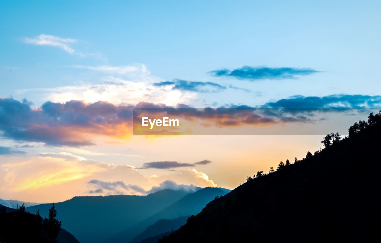 SILHOUETTE MOUNTAINS AGAINST SKY DURING SUNSET