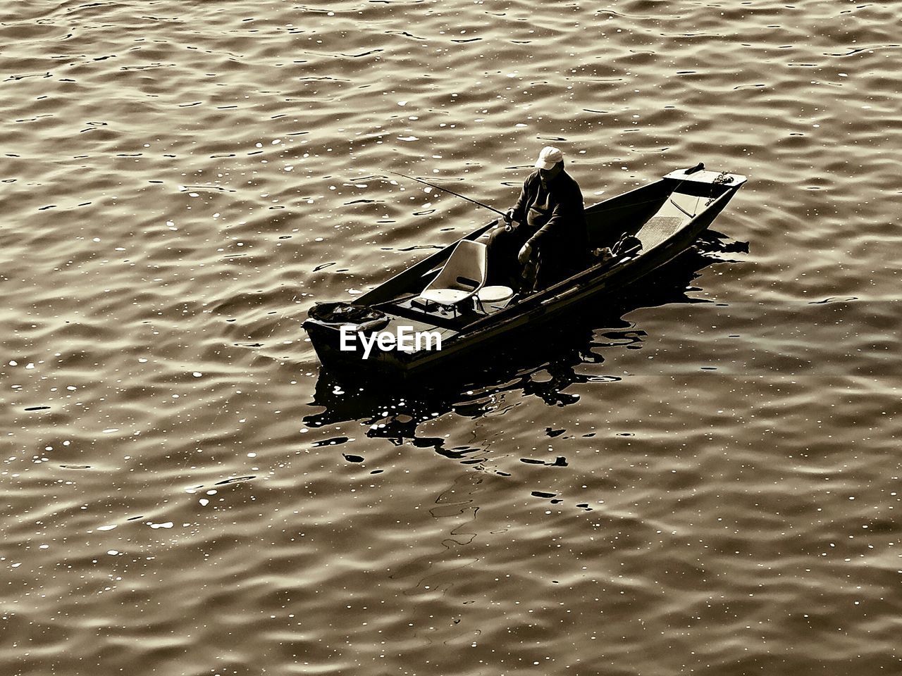 High angle view of man on boat fishing in sea