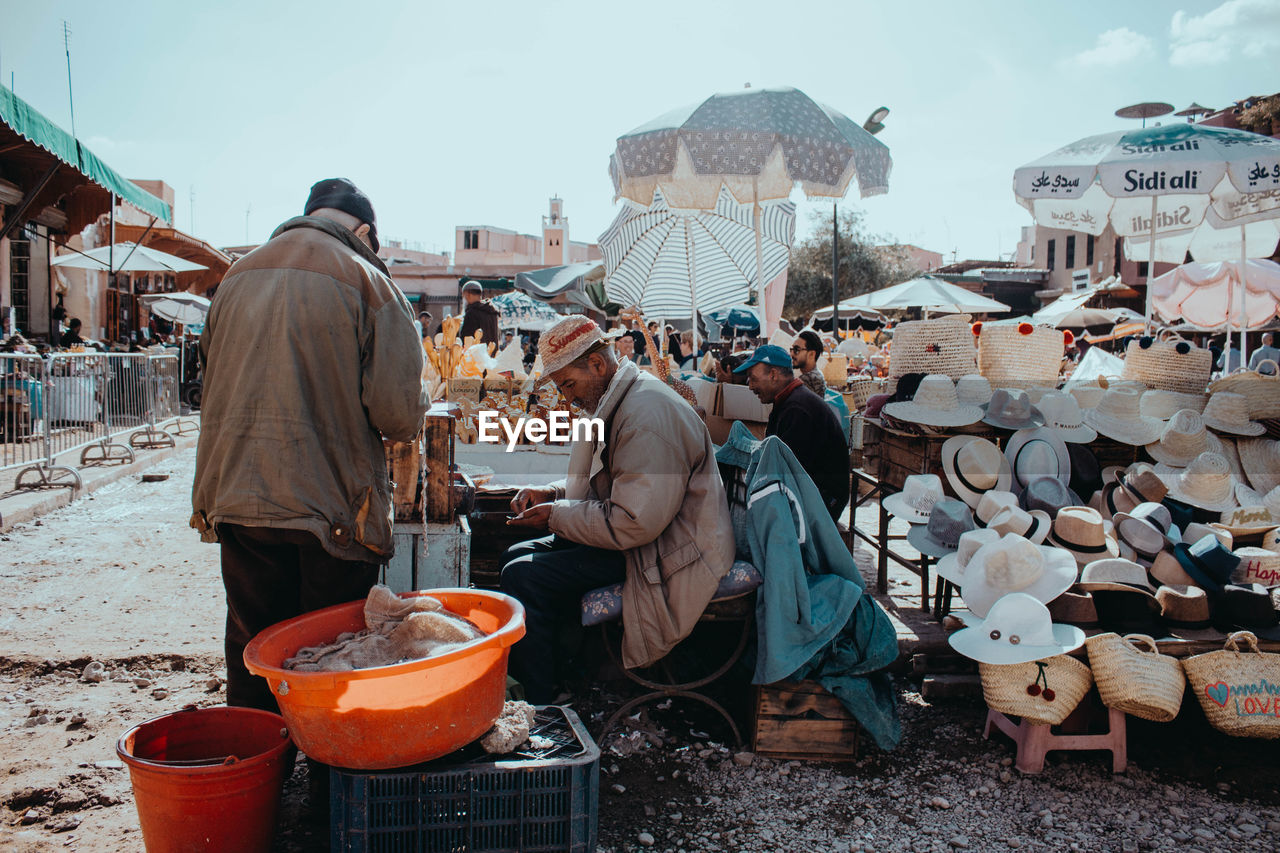 PEOPLE AT MARKET STALL