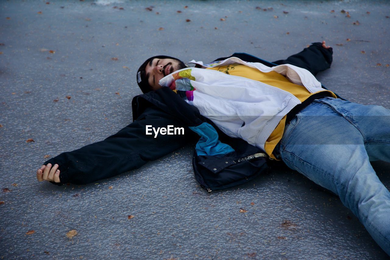 Man lying down on road