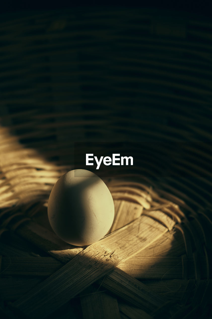 High angle view of an egg in a basket on table