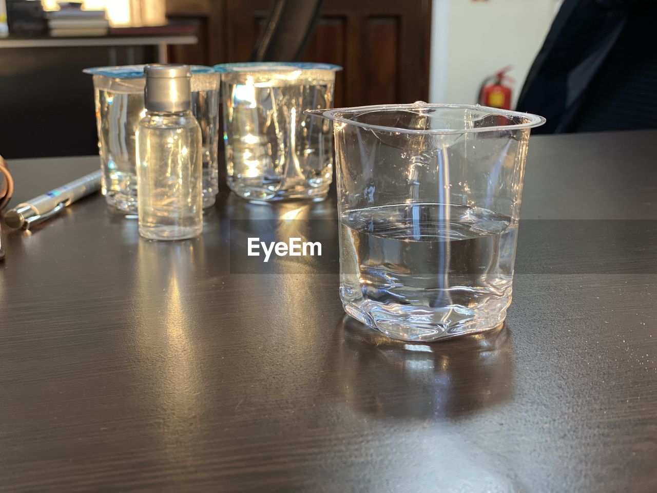 glass, drinking glass, food and drink, drink, household equipment, table, refreshment, indoors, alcohol, water, old fashioned glass, bar, drinking water, business, lighting, distilled beverage, alcoholic beverage, bar counter, shot glass, adult