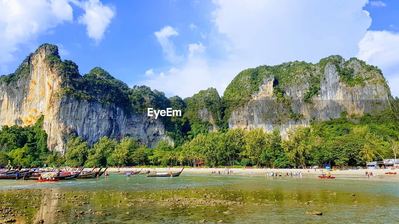 Panoramic view of people and boats on beach