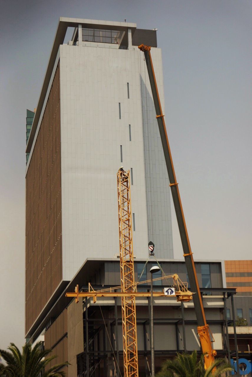 LOW ANGLE VIEW OF INDUSTRIAL BUILDING AGAINST SKY