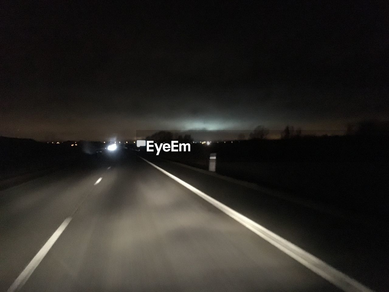 ROAD PASSING THROUGH ILLUMINATED TUNNEL