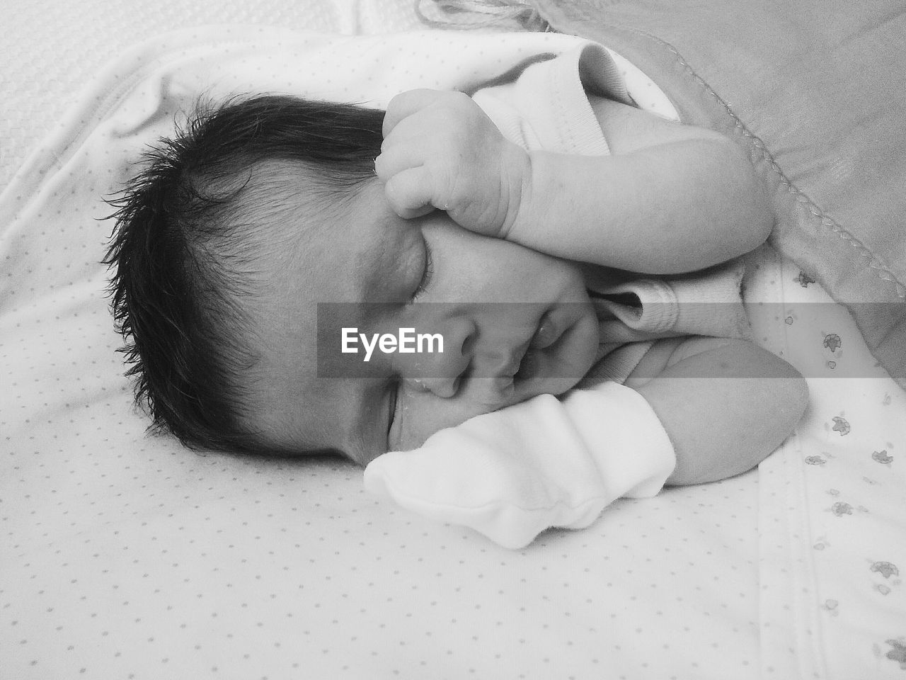 Close-up of baby girl sleeping on bed