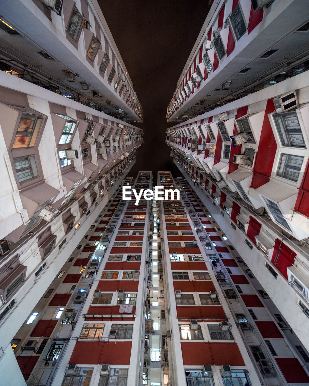 Low angle view of buildings against sky in city at night