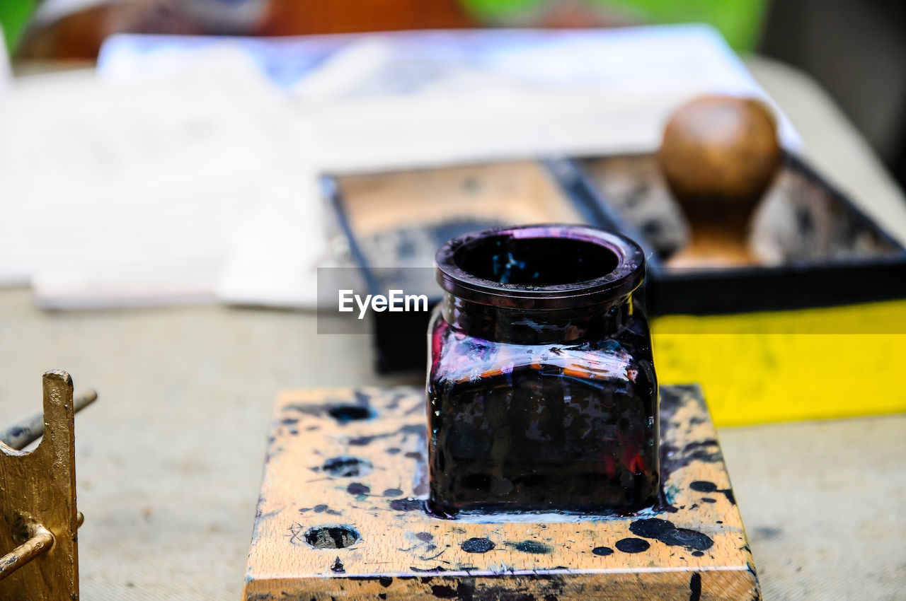Close-up of ink well on table