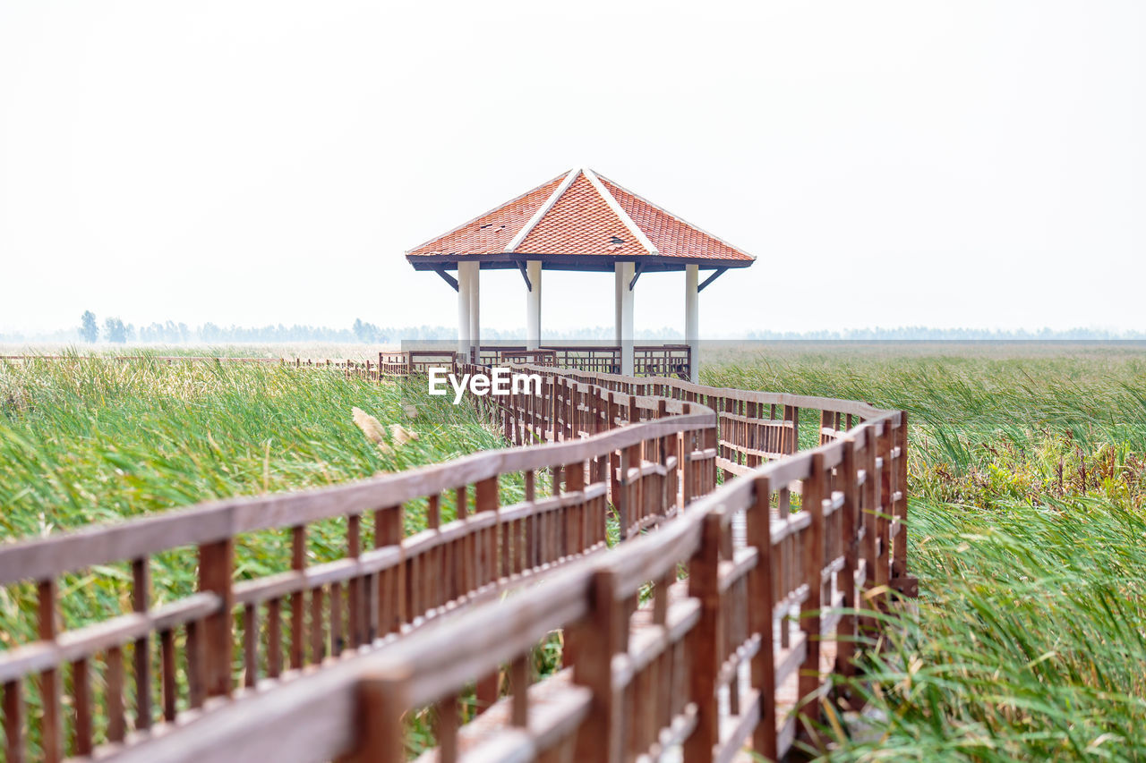 LIFEGUARD HUT ON FIELD AGAINST SKY