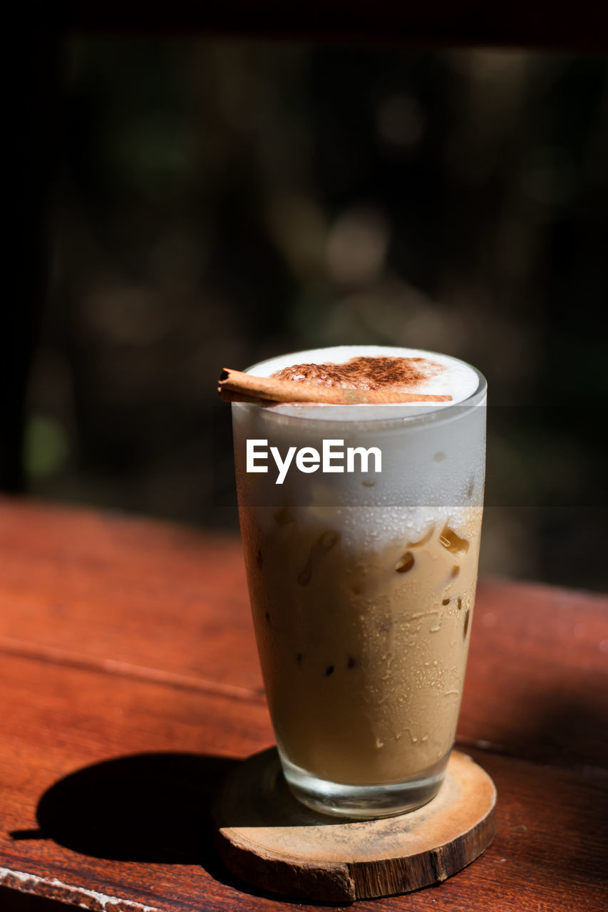 CLOSE-UP OF COFFEE CUP ON GLASS