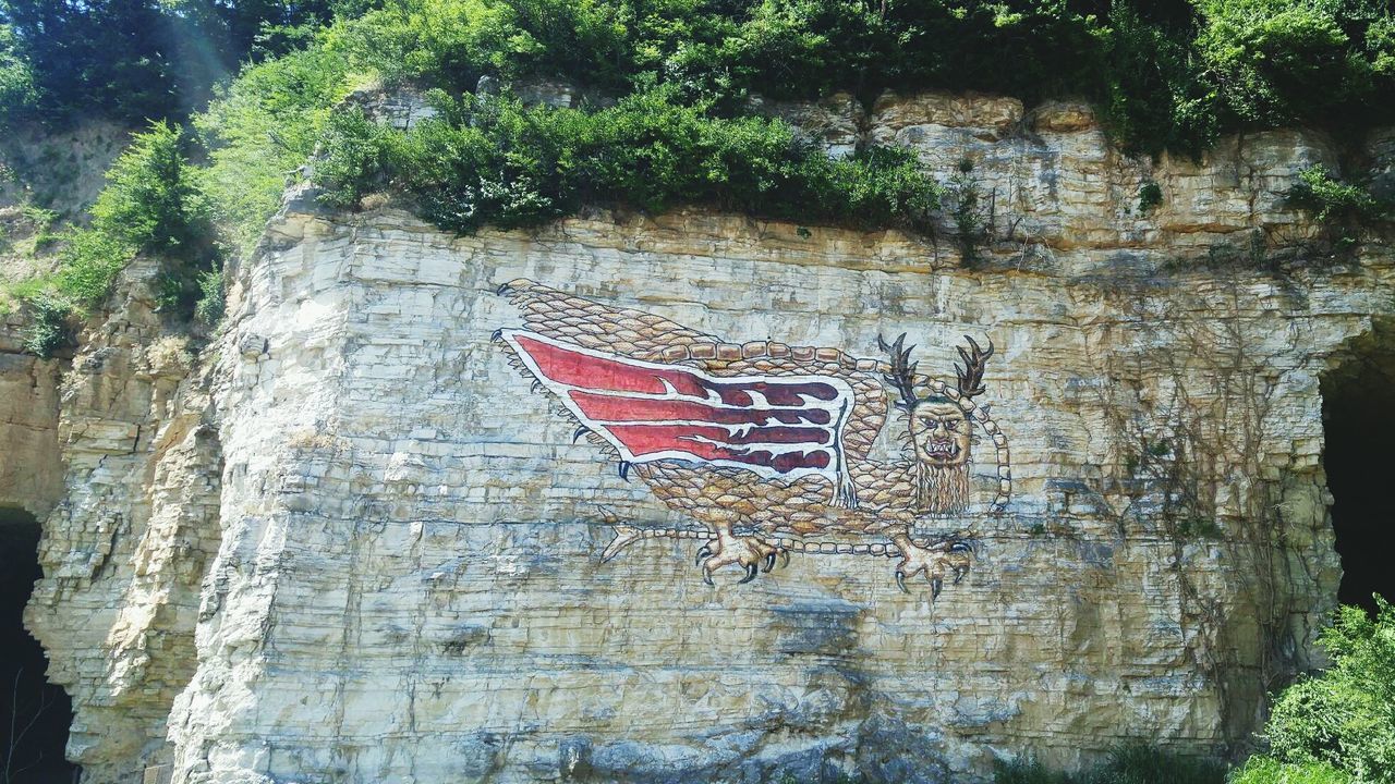 Low angle view of mural on rock formation