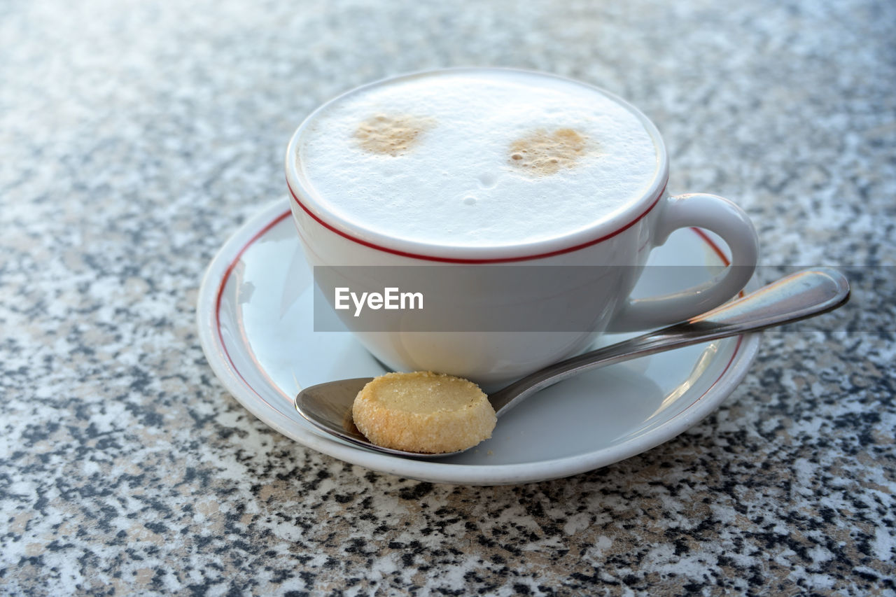 food and drink, drink, mug, coffee, cup, refreshment, crockery, coffee cup, saucer, hot drink, spoon, food, still life, cappuccino, no people, eating utensil, latte, frothy drink, freshness, kitchen utensil, table, close-up, high angle view, cafe