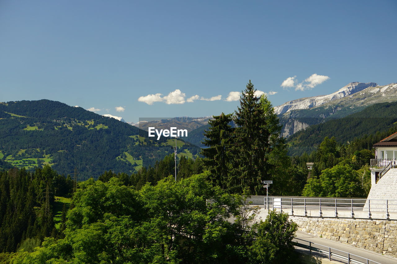 Scenic view of trees and mountains against sky