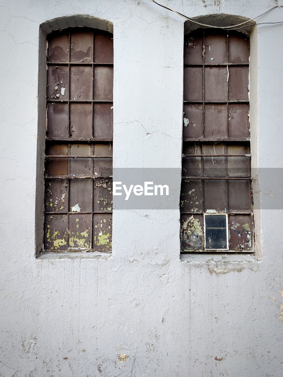 Closed window of old factory building.