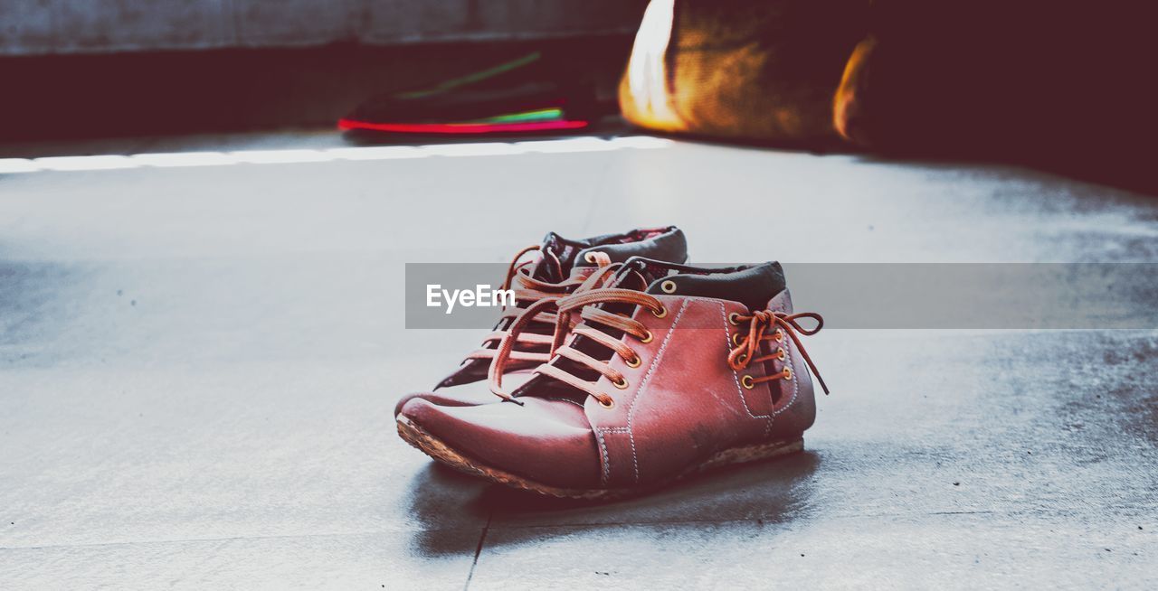 Close-up of red shoes on floor