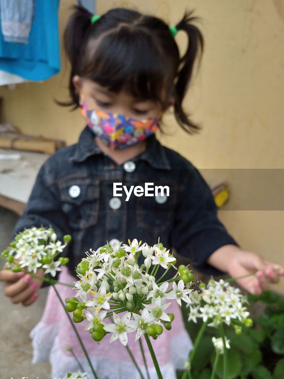 close-up of girl playing with flowers