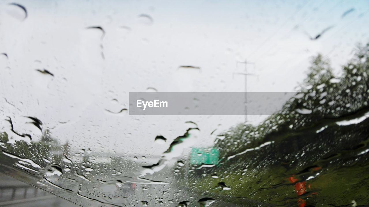 CLOSE-UP OF WATERDROPS ON GLASS WINDOW