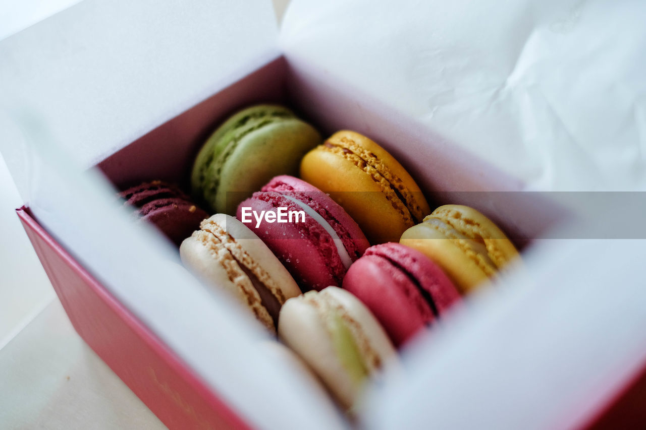 High angle view of macaroons in box on table
