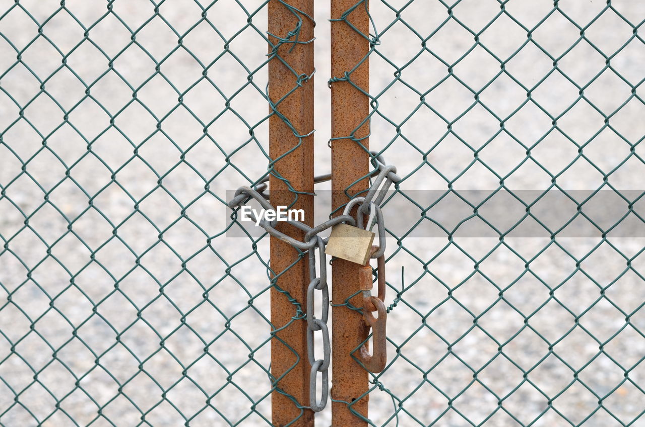 FULL FRAME SHOT OF CHAINLINK FENCE WITH METAL GATE