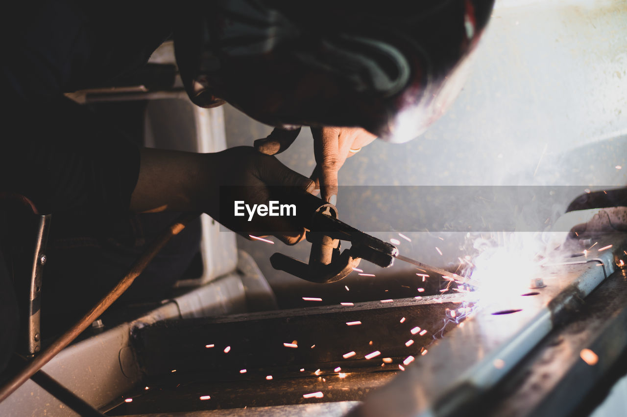 Cropped image of man welding metal