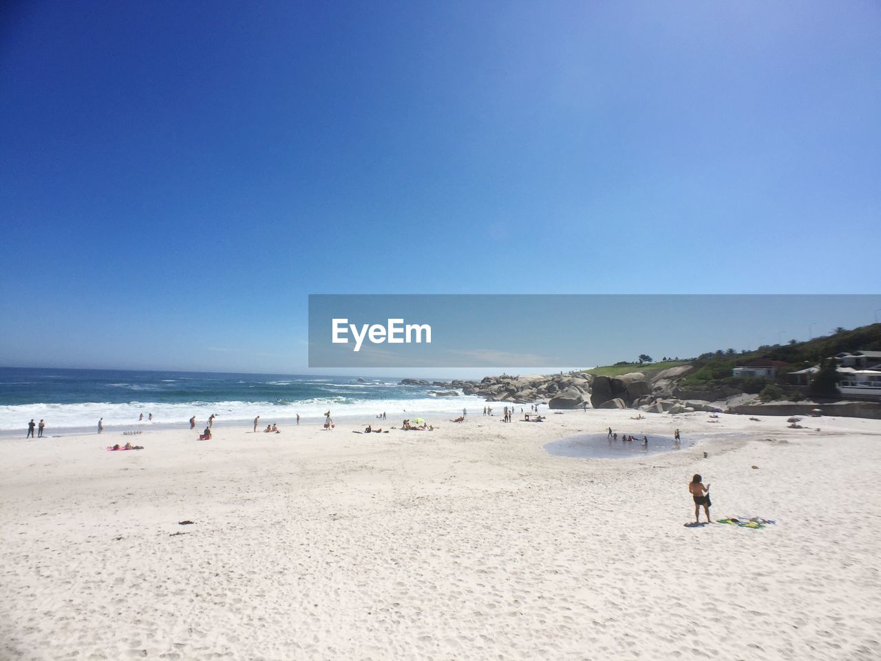 Scenic view of beach against clear blue sky