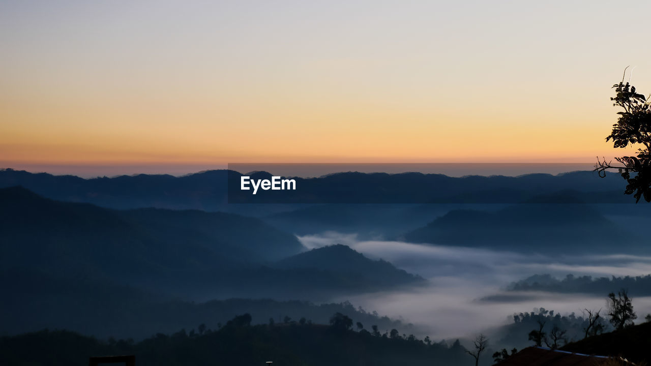 Scenic view of silhouette mountains against sky during sunset on the morning