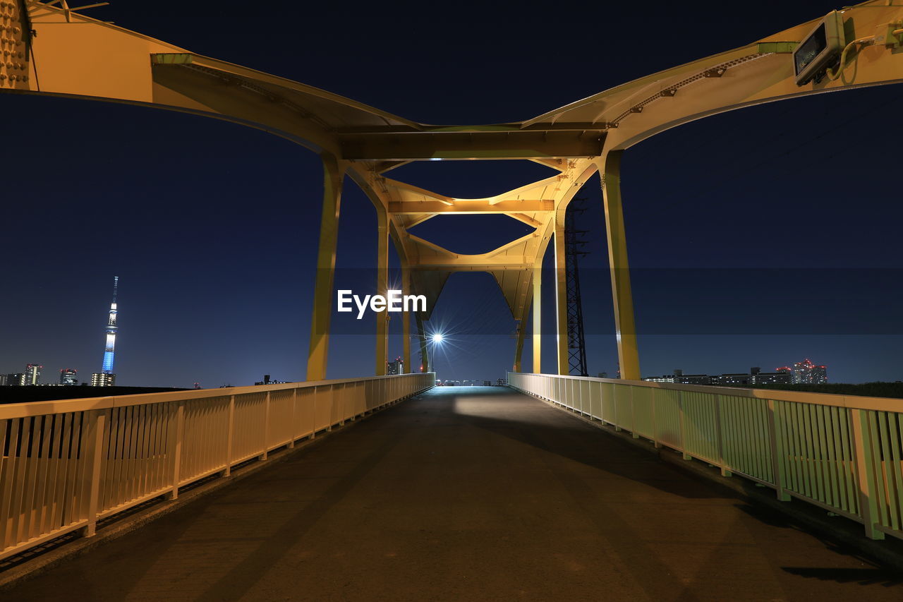 Empty bridge against clear sky at night