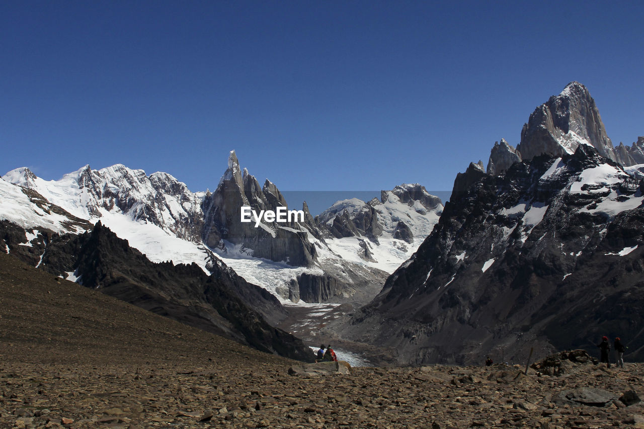 Scenic view of snowcapped mountains against clear blue sky ar fitz roy range