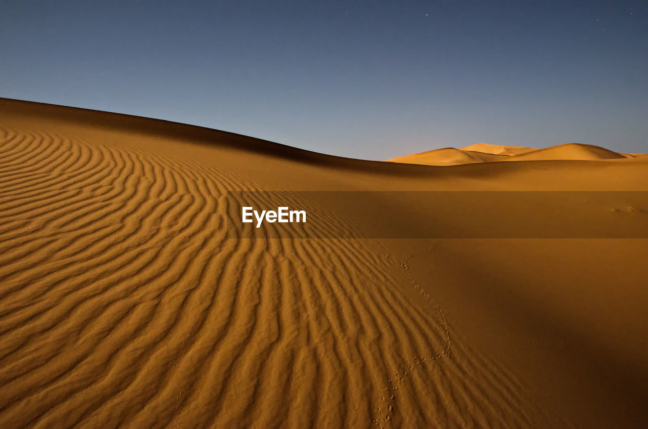 Scenic view of desert against clear sky