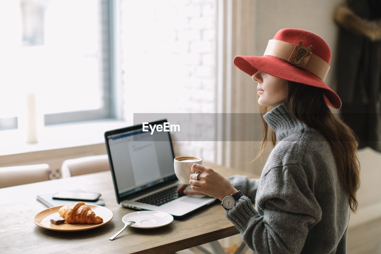 Woman using laptop at table