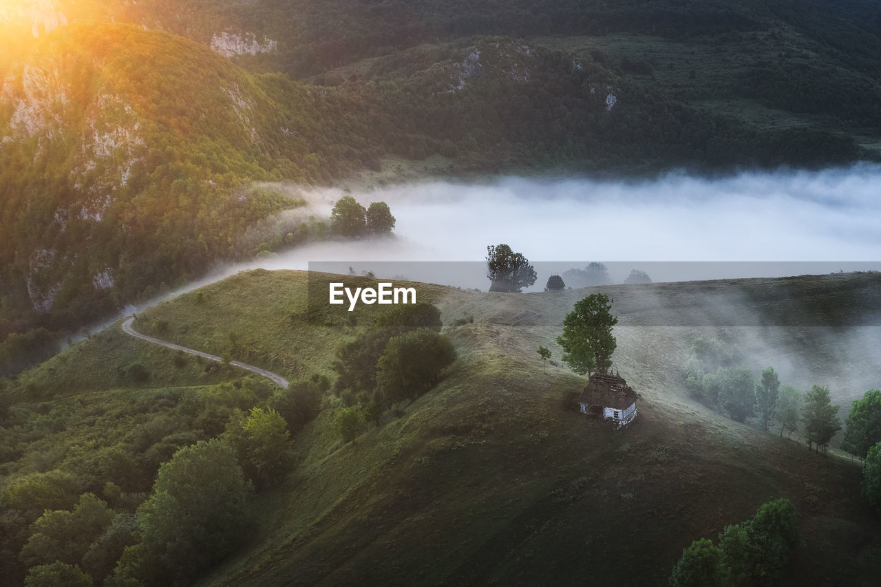 View from drone of incredible atmosphere with foggy hills at sunrise.