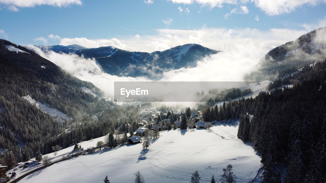 Scenic view of snow covered mountains against sky