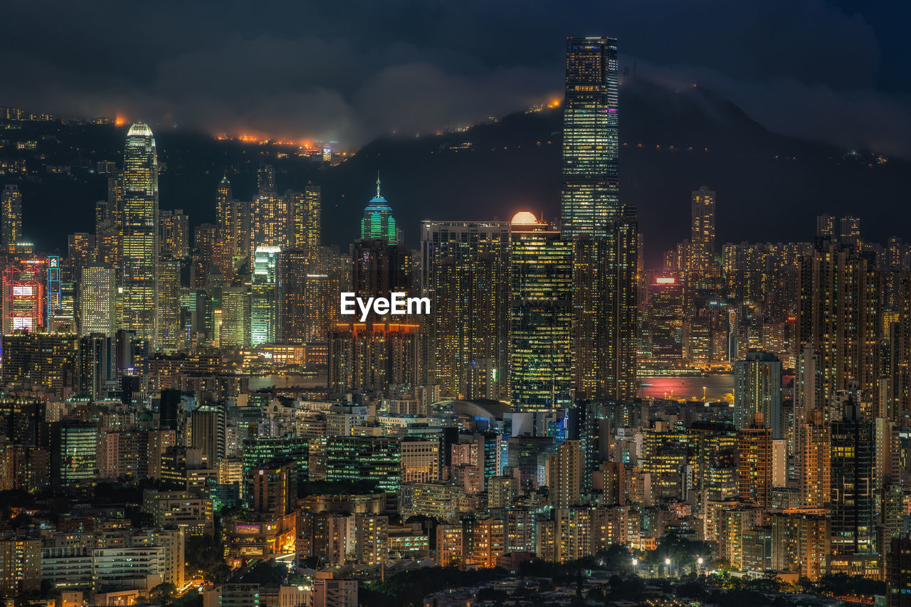 Illuminated cityscape against sky at night