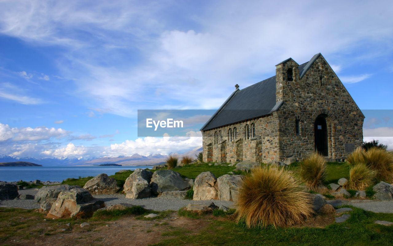 Church of the good shepherd by lake tekapo against sky