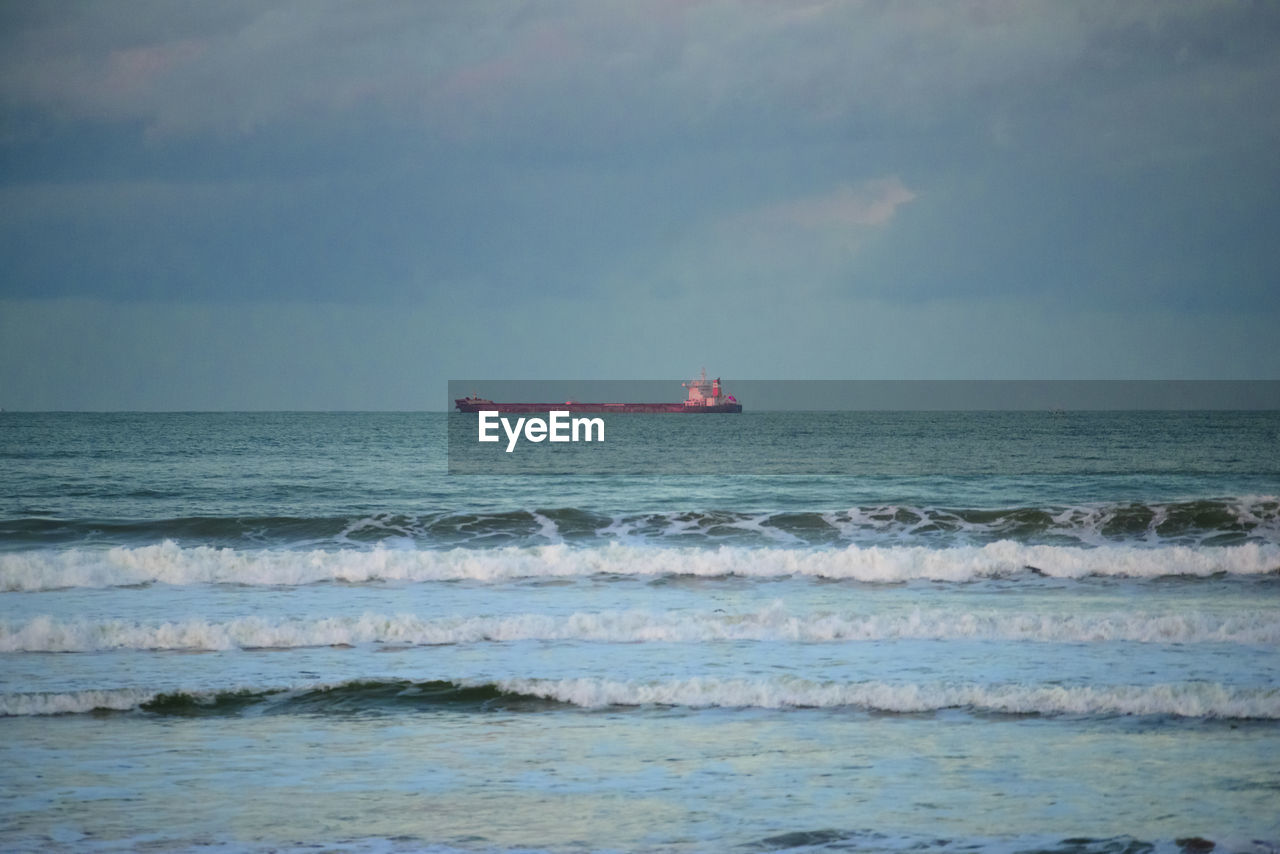 Cargo ship on the horizon with dark day weather