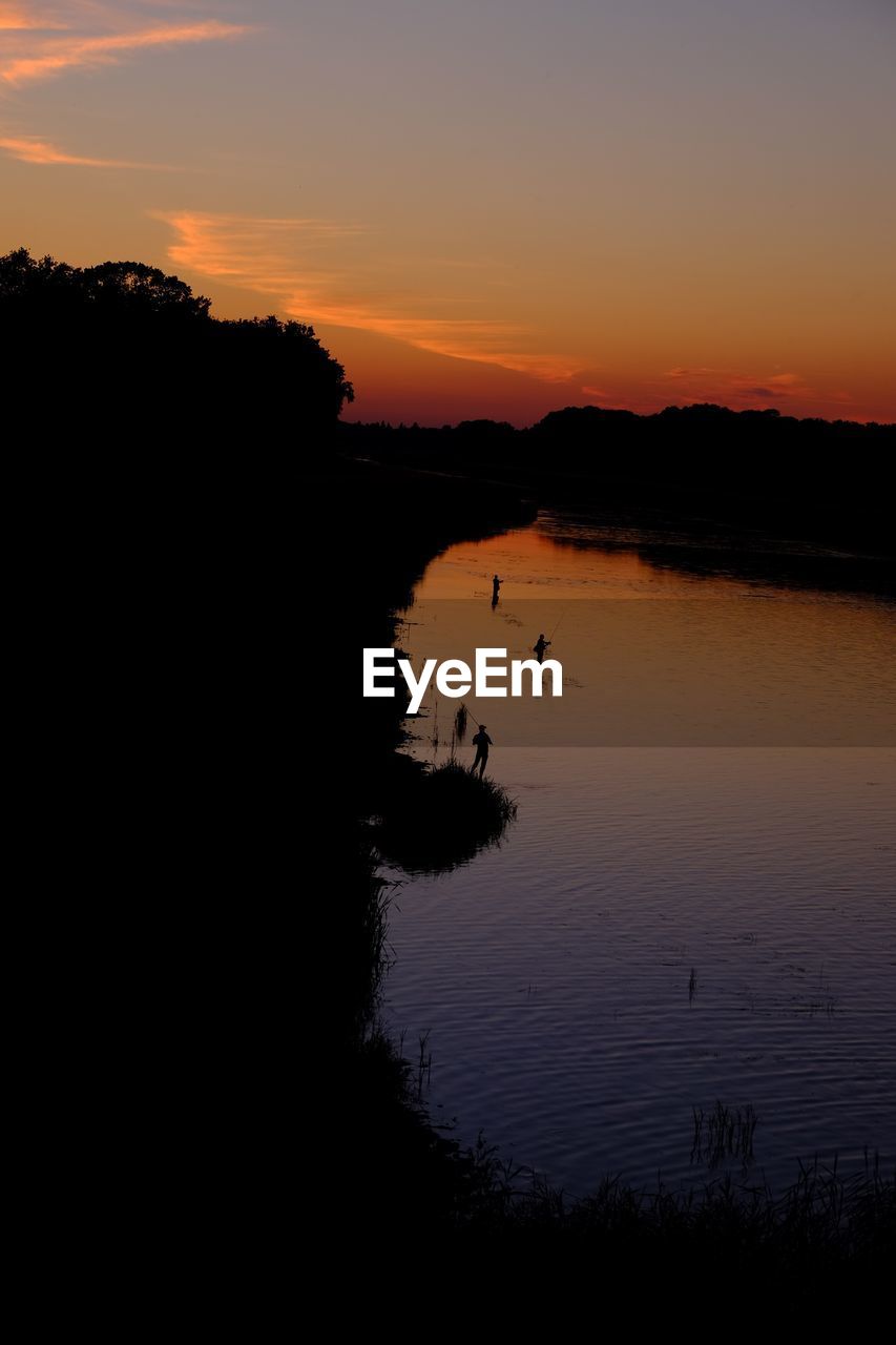 SCENIC VIEW OF LAKE AT SUNSET