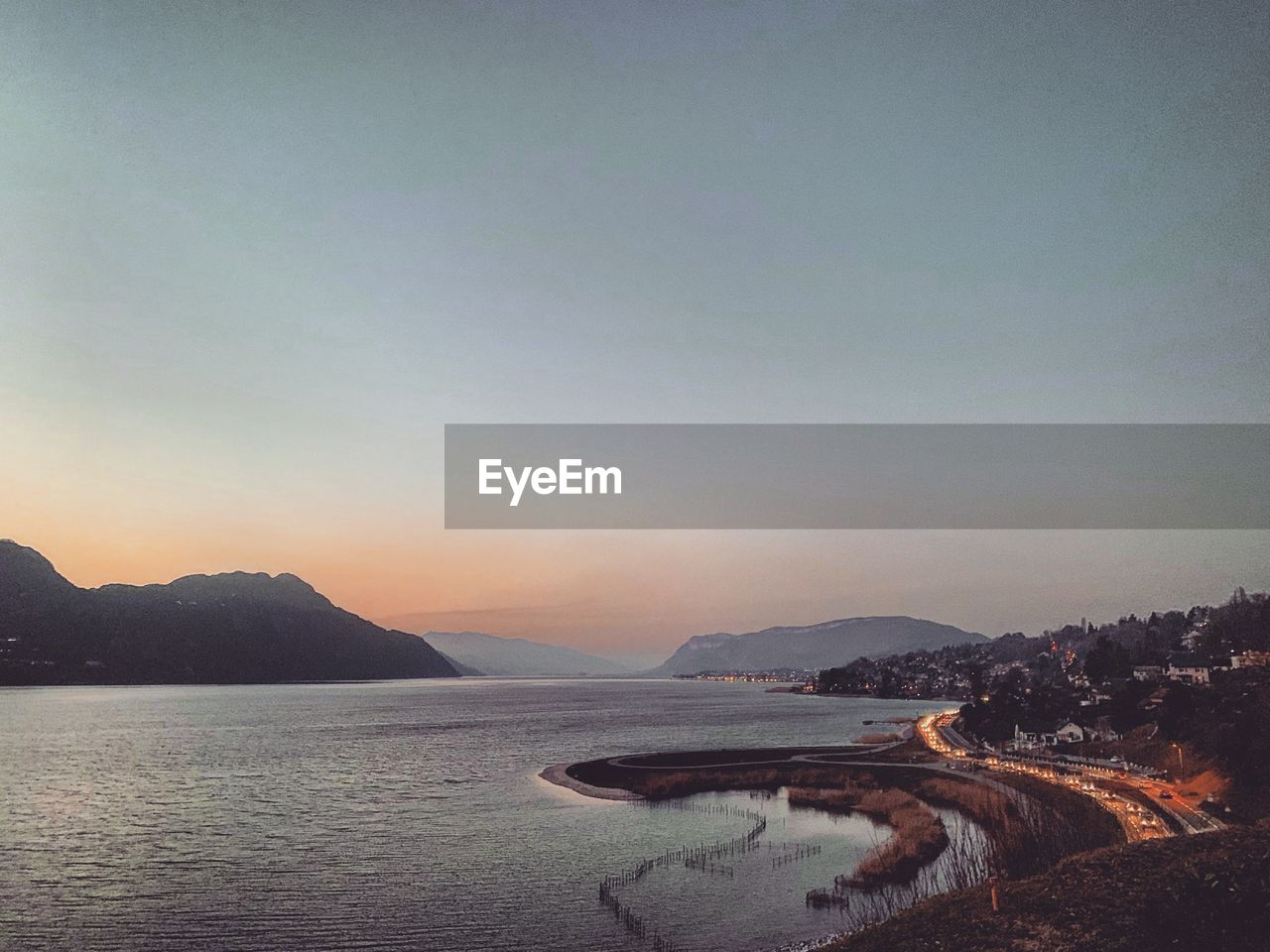 Scenic view of sea against clear sky during sunset