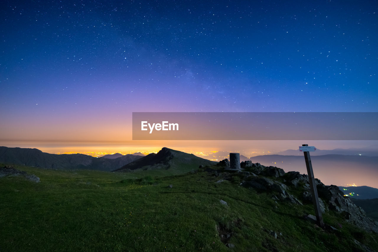 Scenic view of mountains against sky at night