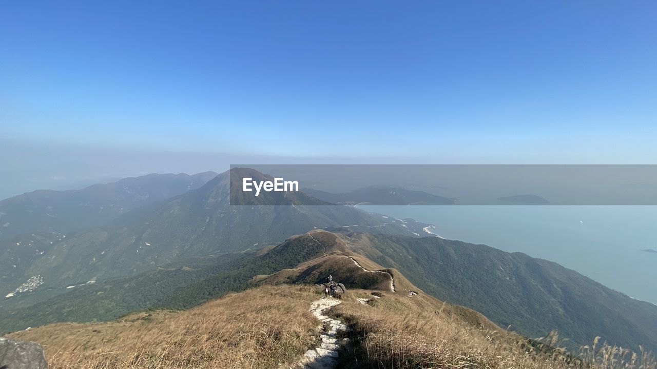 High angle view of mountains against clear blue sky