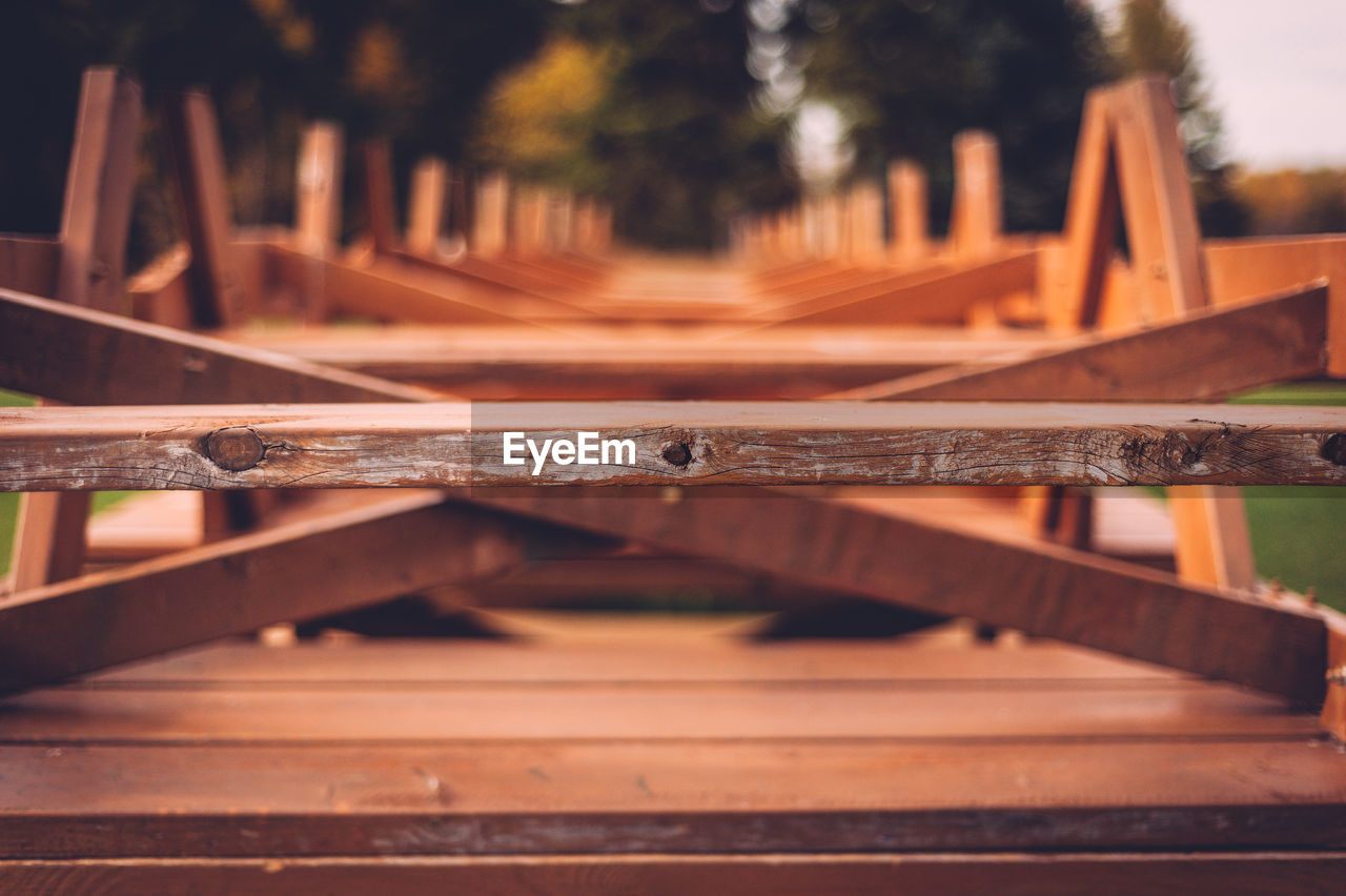 Row of upside down picnic tables stacks at park