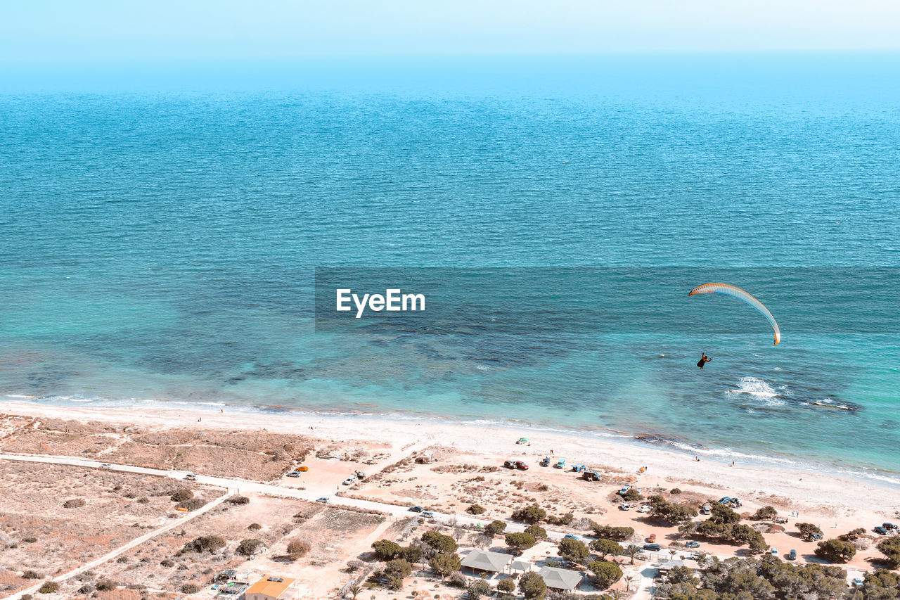High angle view of person paragliding against sea