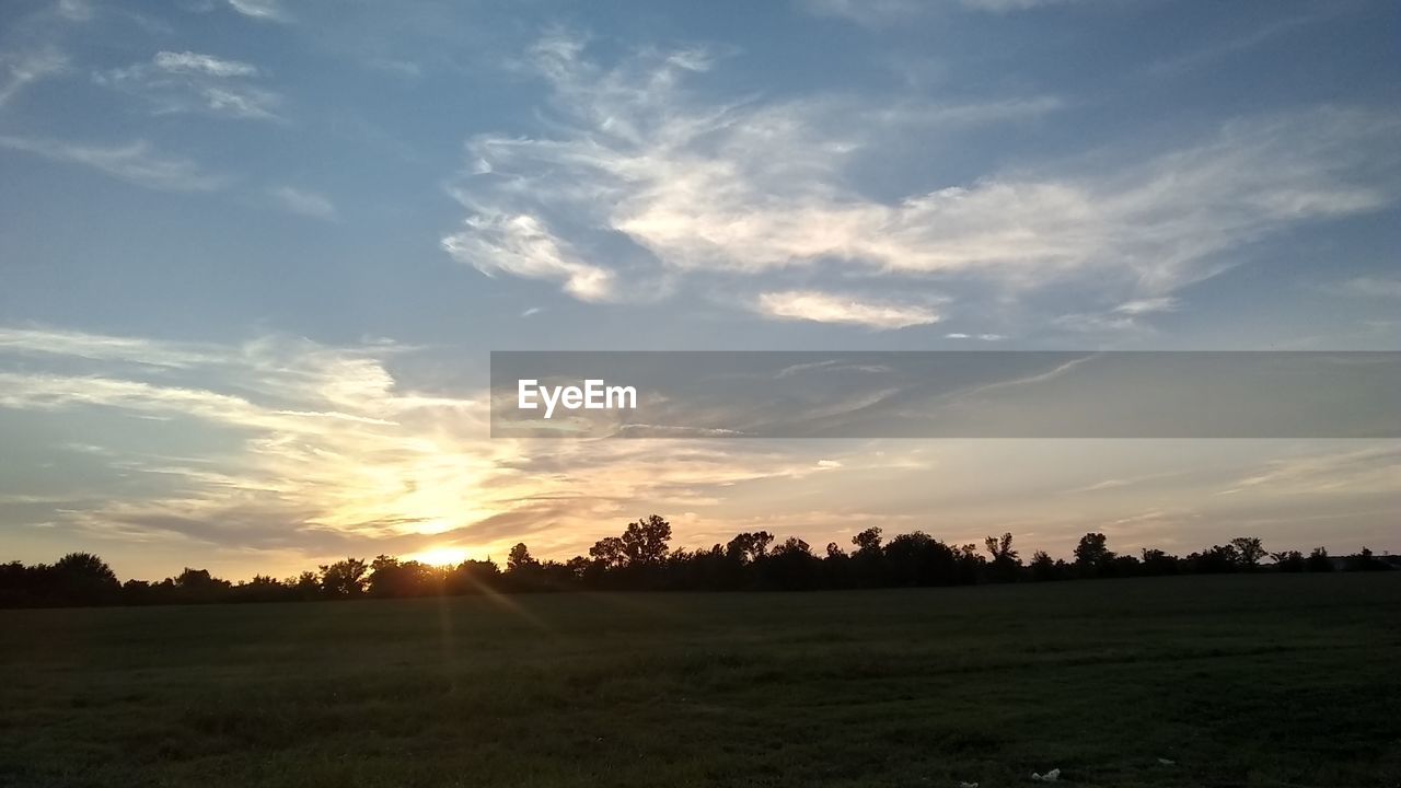 SCENIC VIEW OF FIELD AGAINST SKY DURING SUNSET