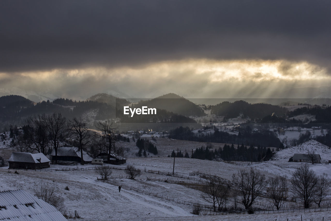 Scenic view of snowcapped landscape against sky during winter