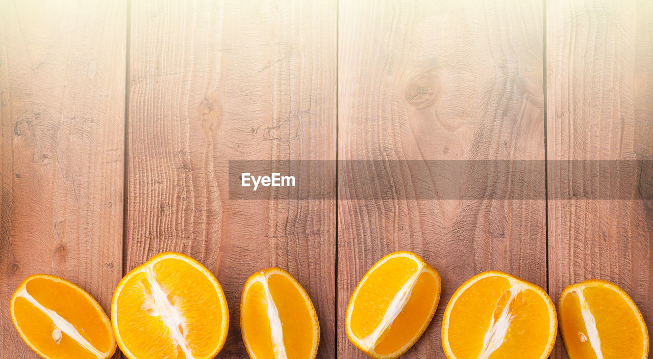wood, orange, orange color, food and drink, food, citrus fruit, healthy eating, fruit, yellow, produce, no people, wellbeing, plant, freshness, indoors, slice, close-up, in a row, backgrounds, still life, group of objects, side by side, directly above, copy space, cross section