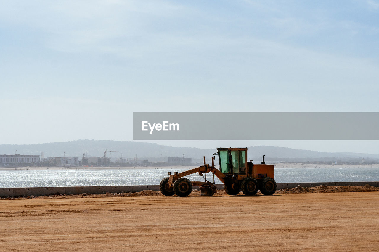 Road grader by the sea, essaouira, morocco.