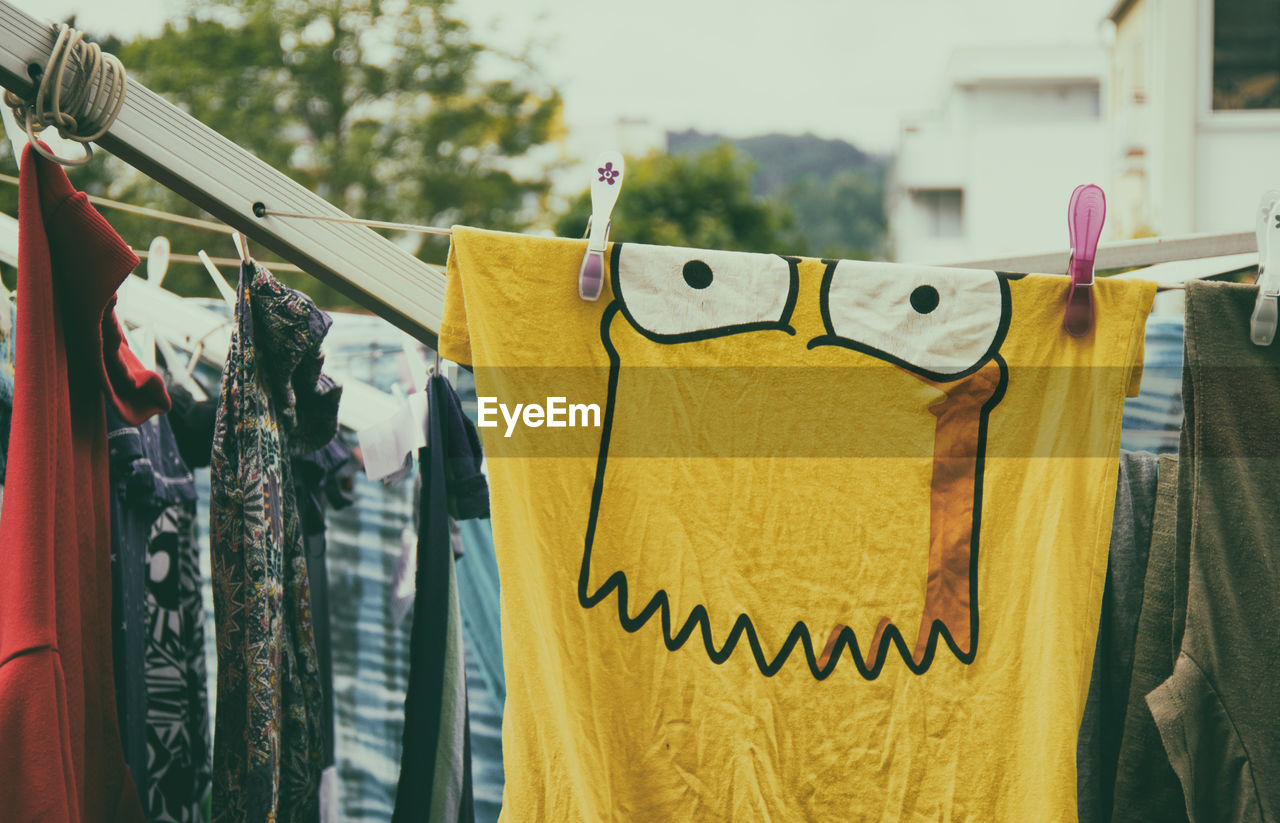 CLOSE-UP OF CLOTHES DRYING HANGING ON CLOTHESLINE