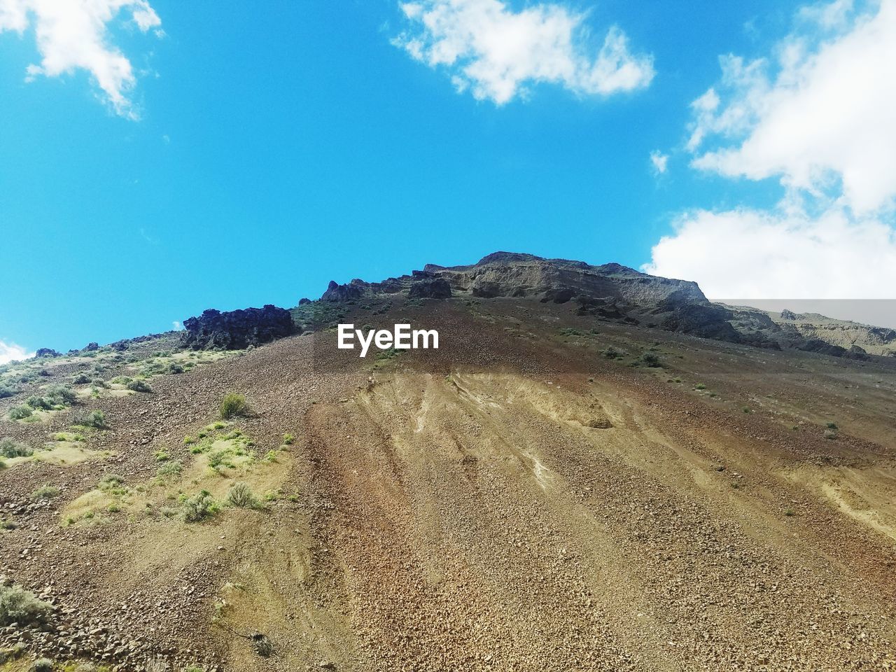 SCENIC VIEW OF MOUNTAINS AGAINST BLUE SKY