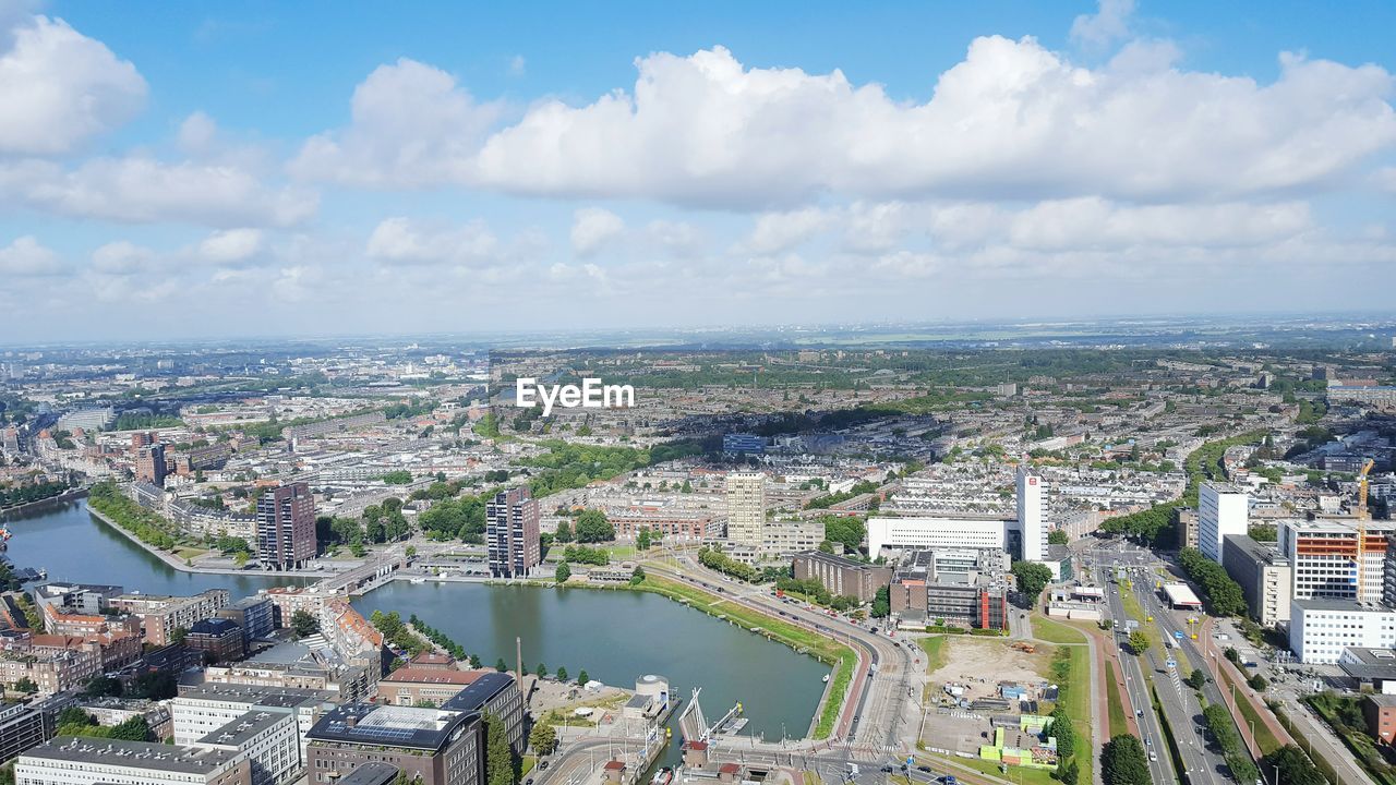 High angle view of cityscape against cloudy sky