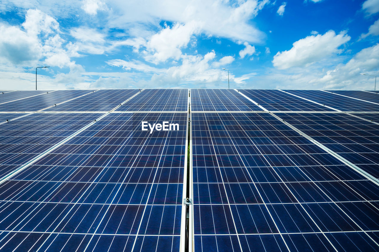 Low angle view of solar panels against sky