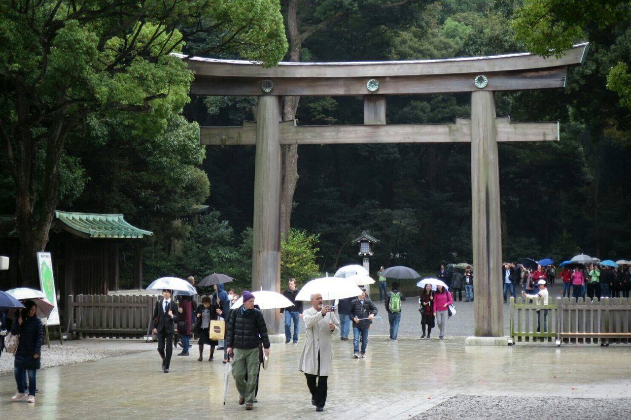 Crowd at torii gate on shinto shrine 